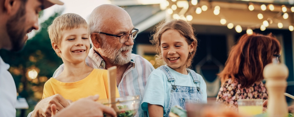 A grandfather sitting with his grand children